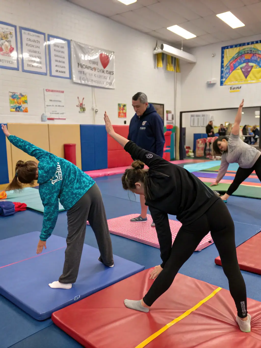 Adults, aged 30-40, are participating in a gymnastics class, performing exercises that improve flexibility, strength, and overall fitness at Avenir Gym MLO.